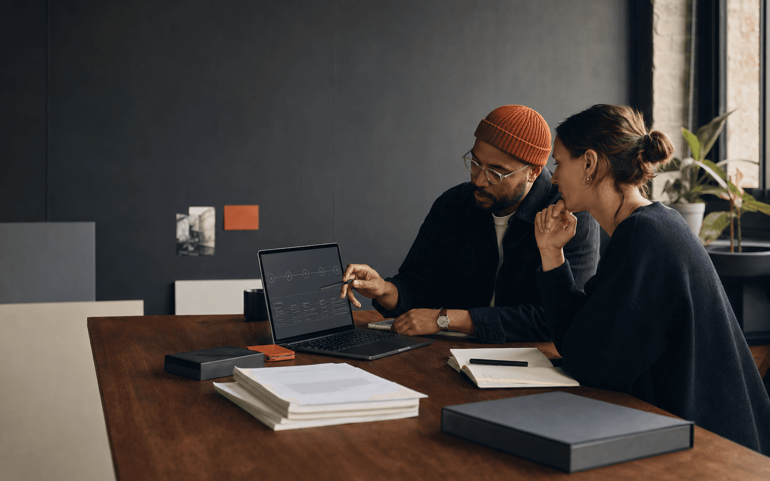 A studio team reviewing system decisions, ownership notes and the next improvement path
